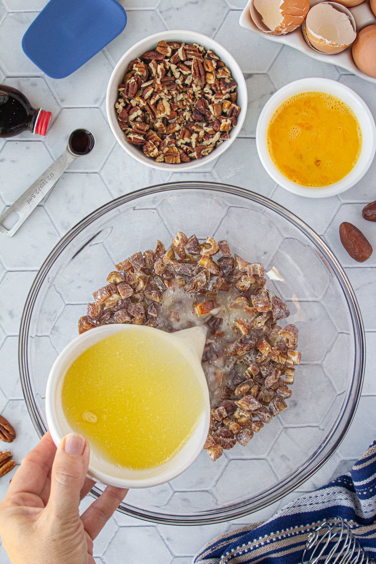 Pouring the melted butter and water over the dates.