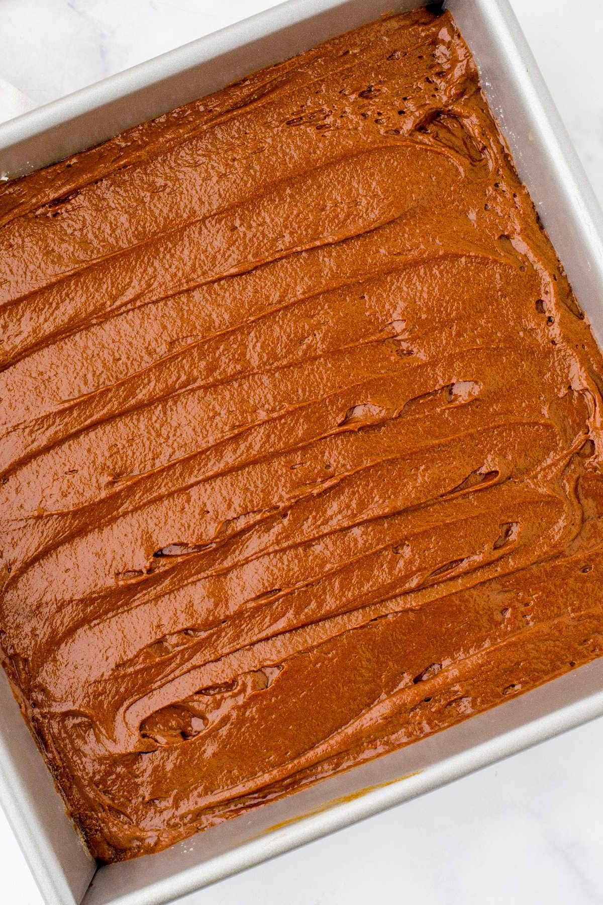 Gingerbread batter in a prepared pan.