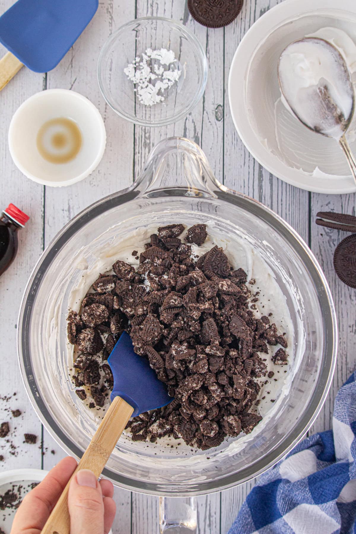 Stirring the Oreo cookies into the pie filling.