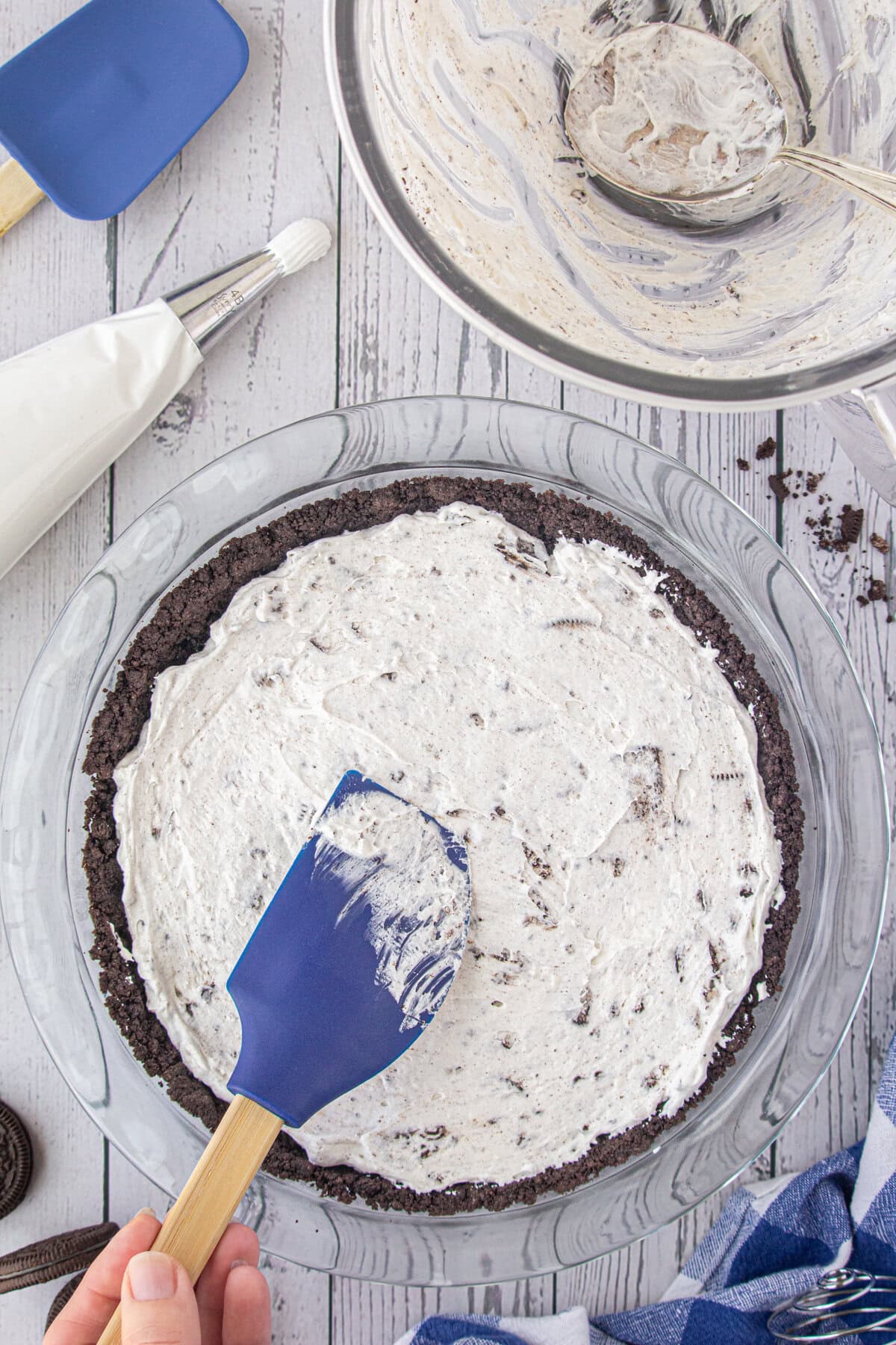 Spreading the Oreo pie filling into the crumb crust.