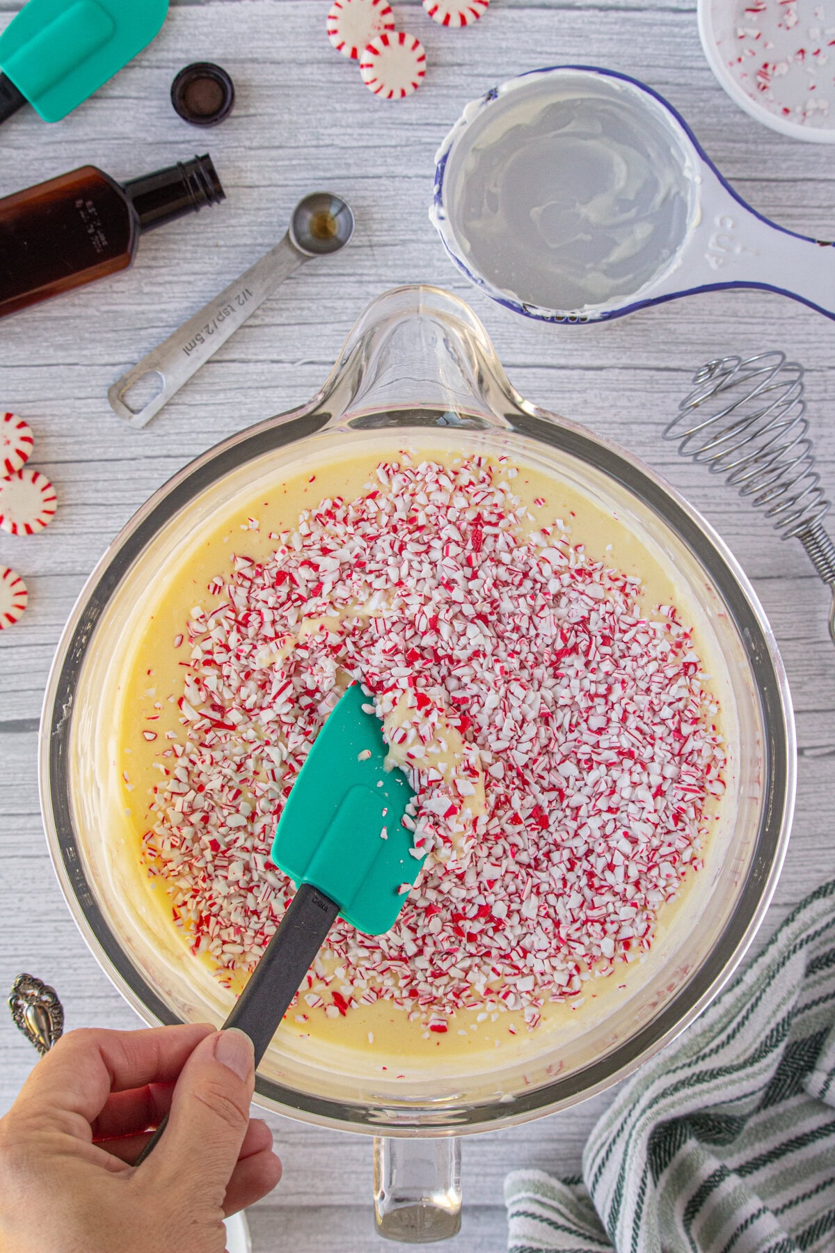 peppermint candy being folded into the cheesecake batter.