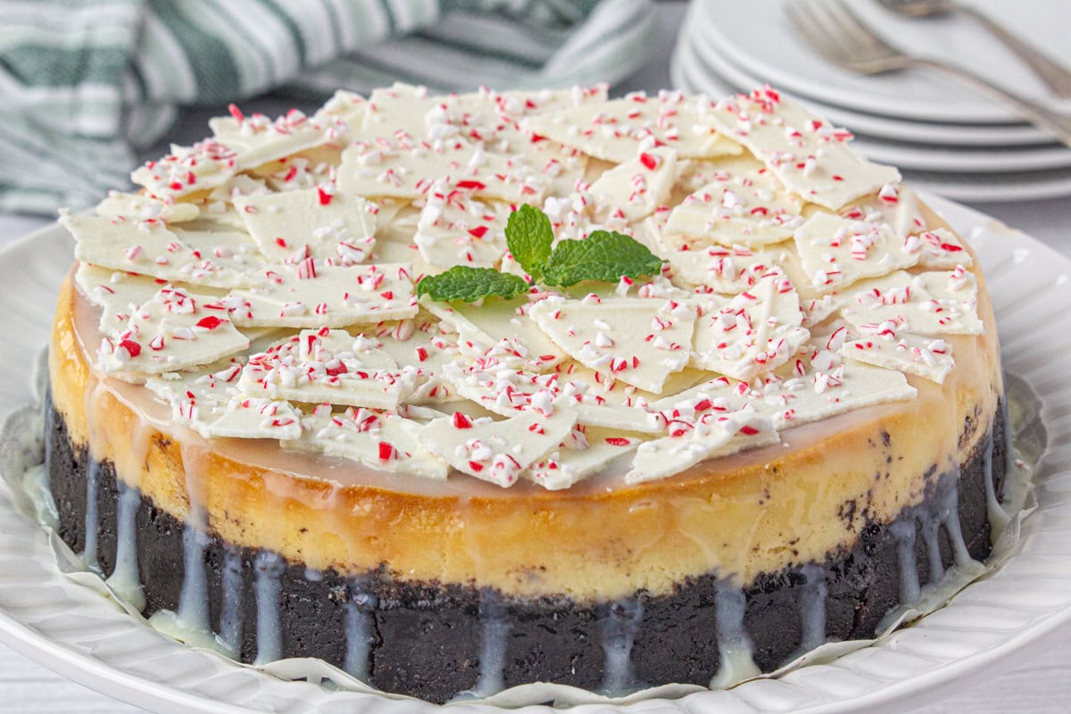 Peppermint bark cheesecake on a serving dish.