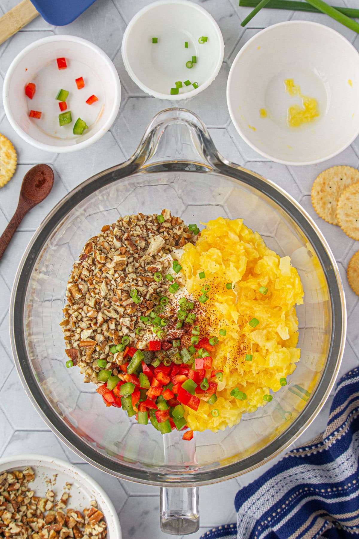 Adding the pineapple cheese ball ingredients to a mixing bowl.