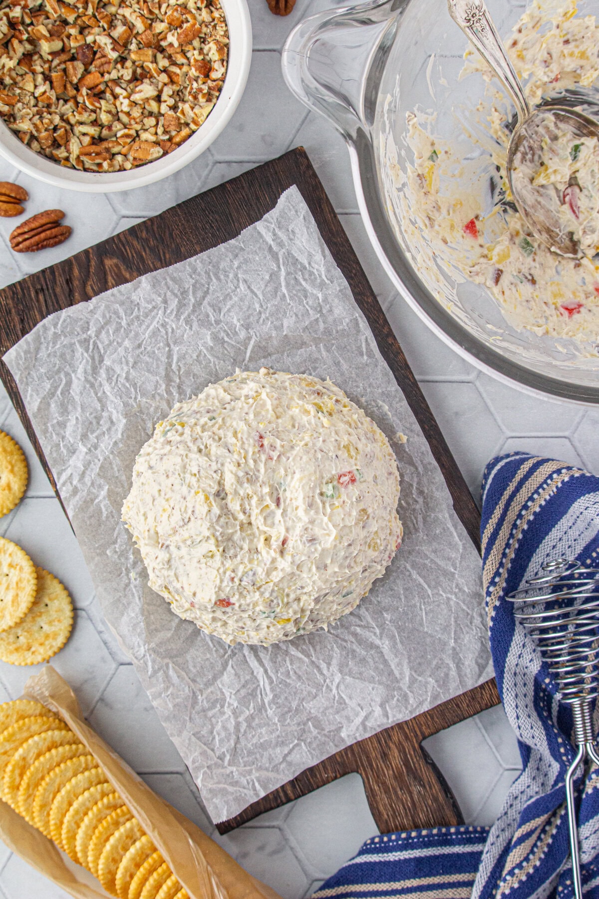 The cheese ball formed on parchment paper.