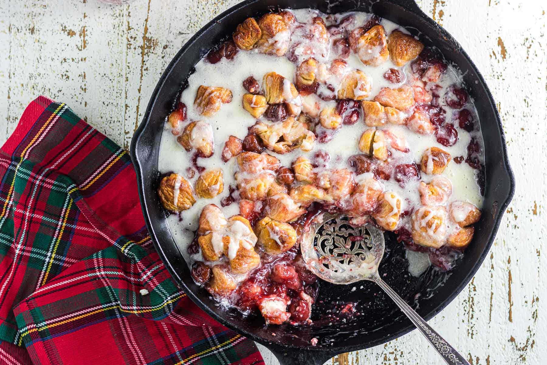 Overhead view of cherry bubble up in a skillet with a vanilla glaze.