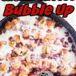 Overhead view of the cherry bubble up in an iron skillet with text title overlay for Pinterest.