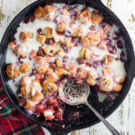 Overhead view of a finished cherry and cream cheese coffee cake with vanilla glaze.