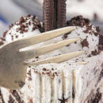 Closeup of a slice of Oreo icebox pie being cut with a fork and a title text overlay for Pinterest.