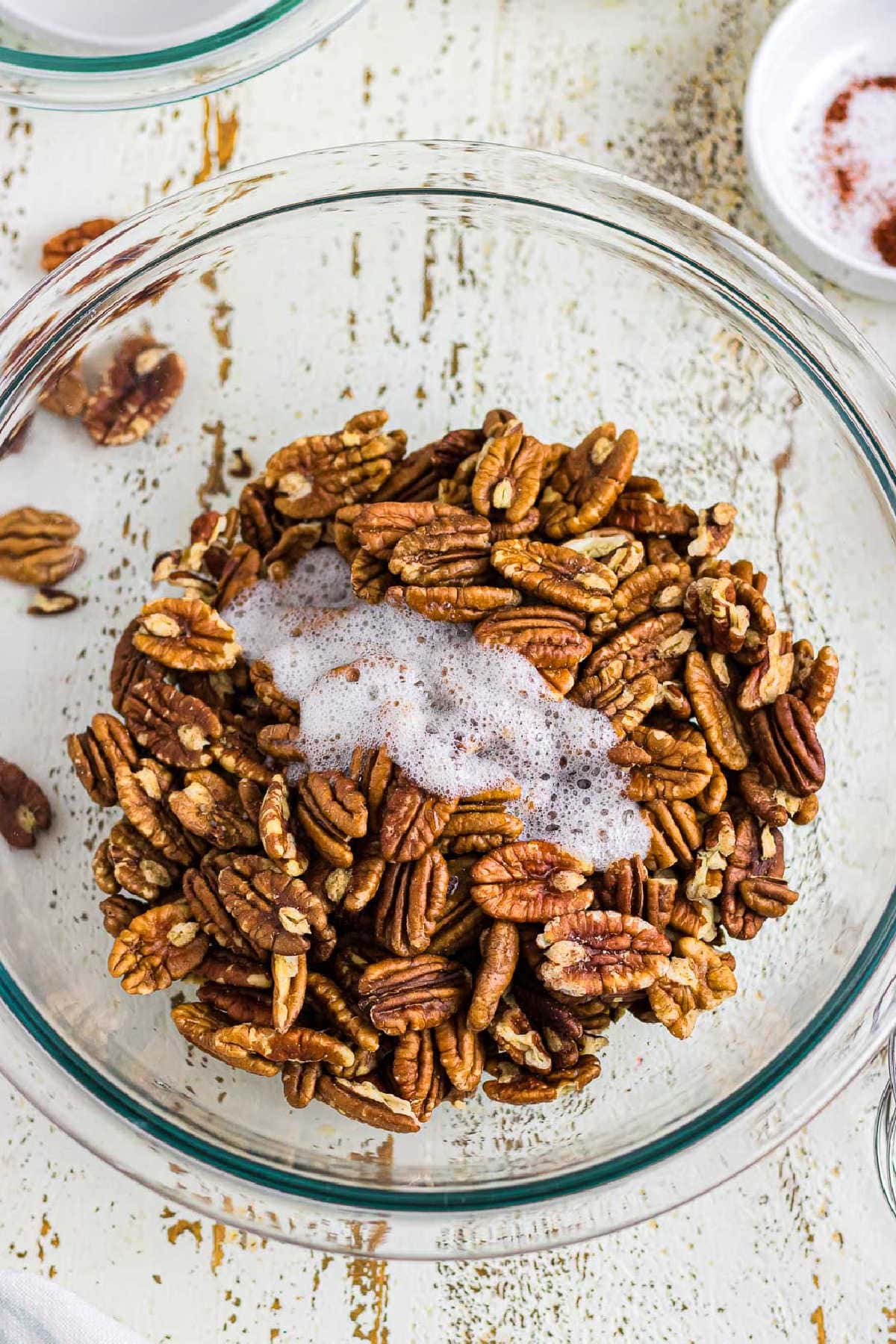 Egg whites poured over pecans.