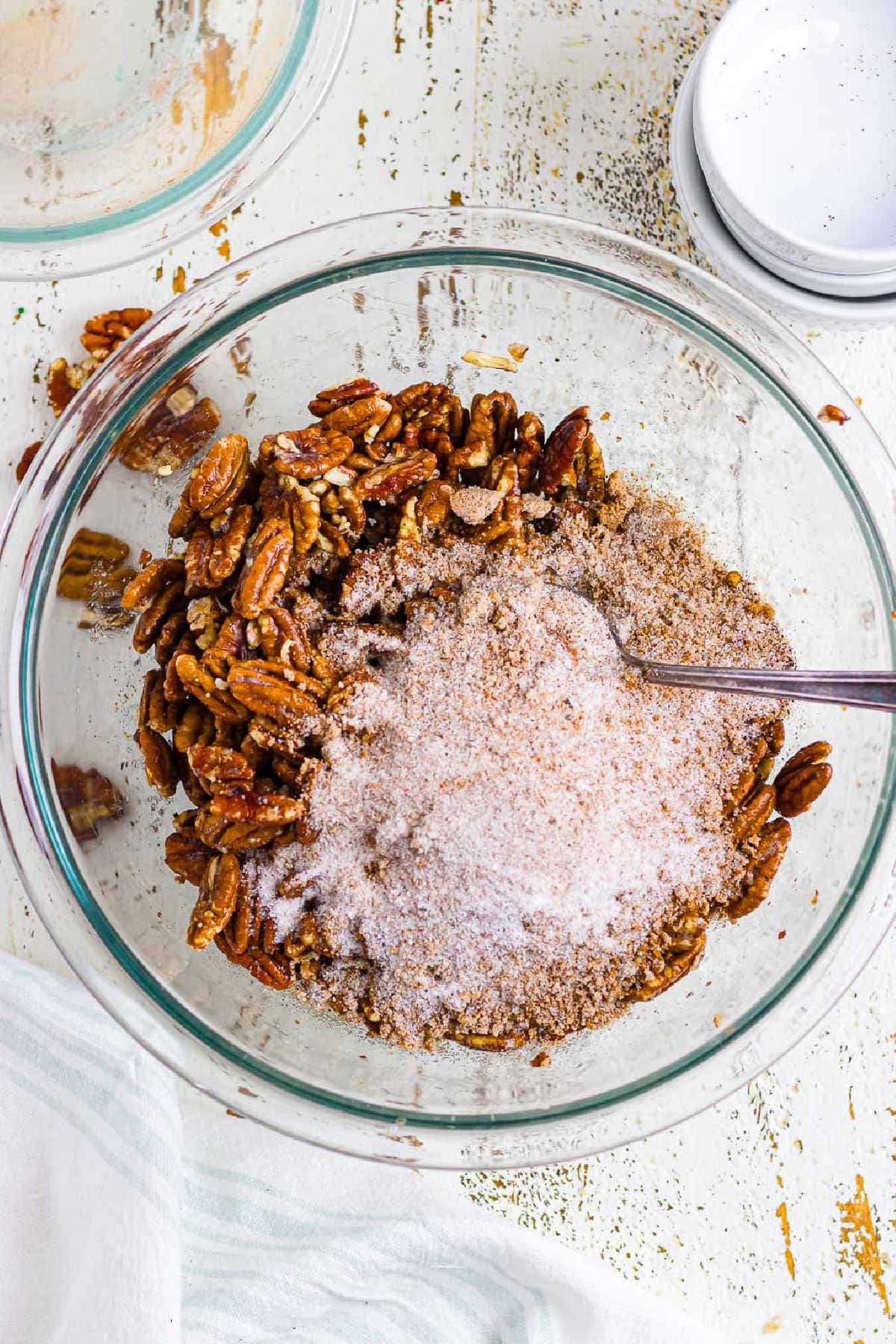 Pecans being coated in the sugar mixture.