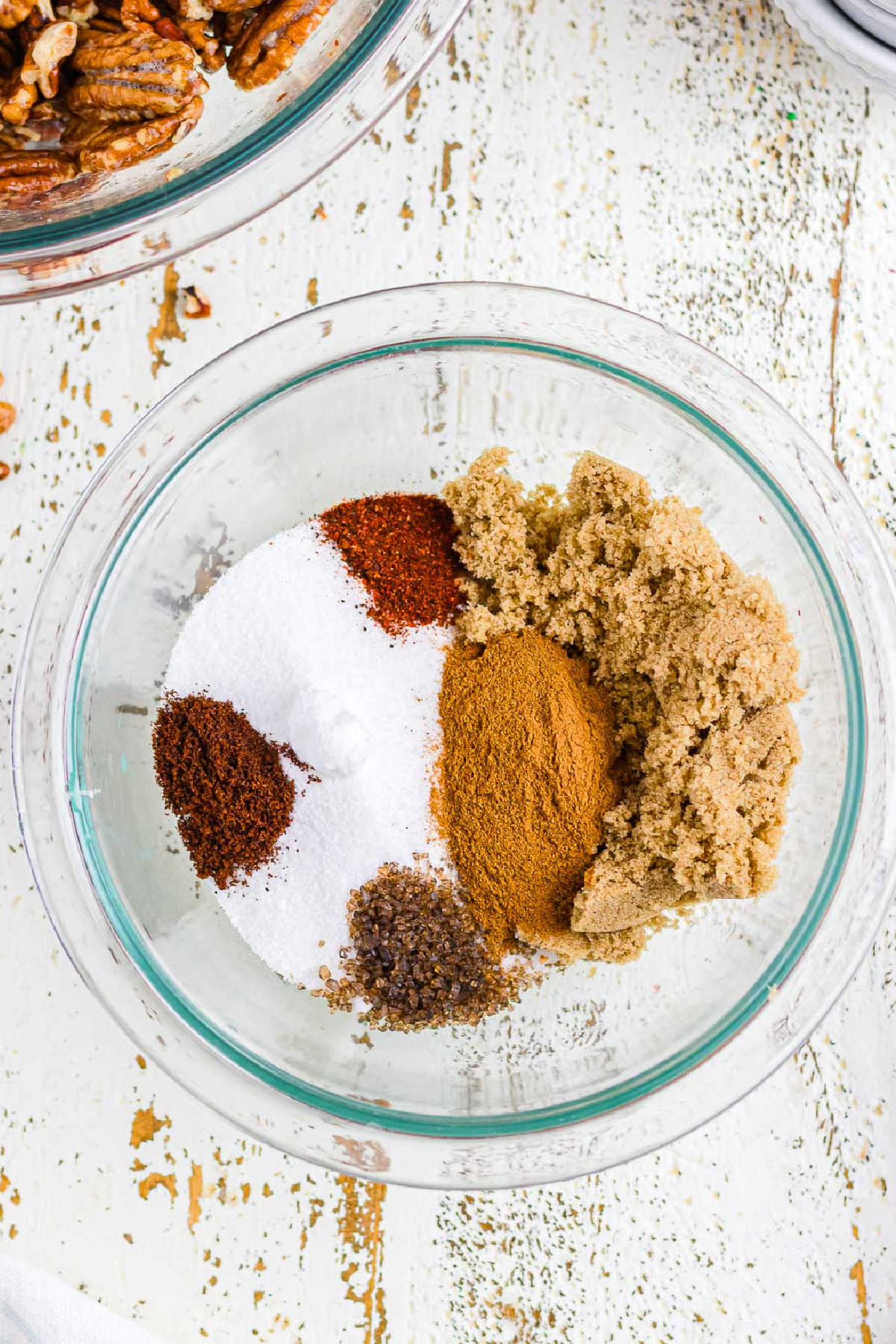 Spices and sugar mixed in a glass bowl.