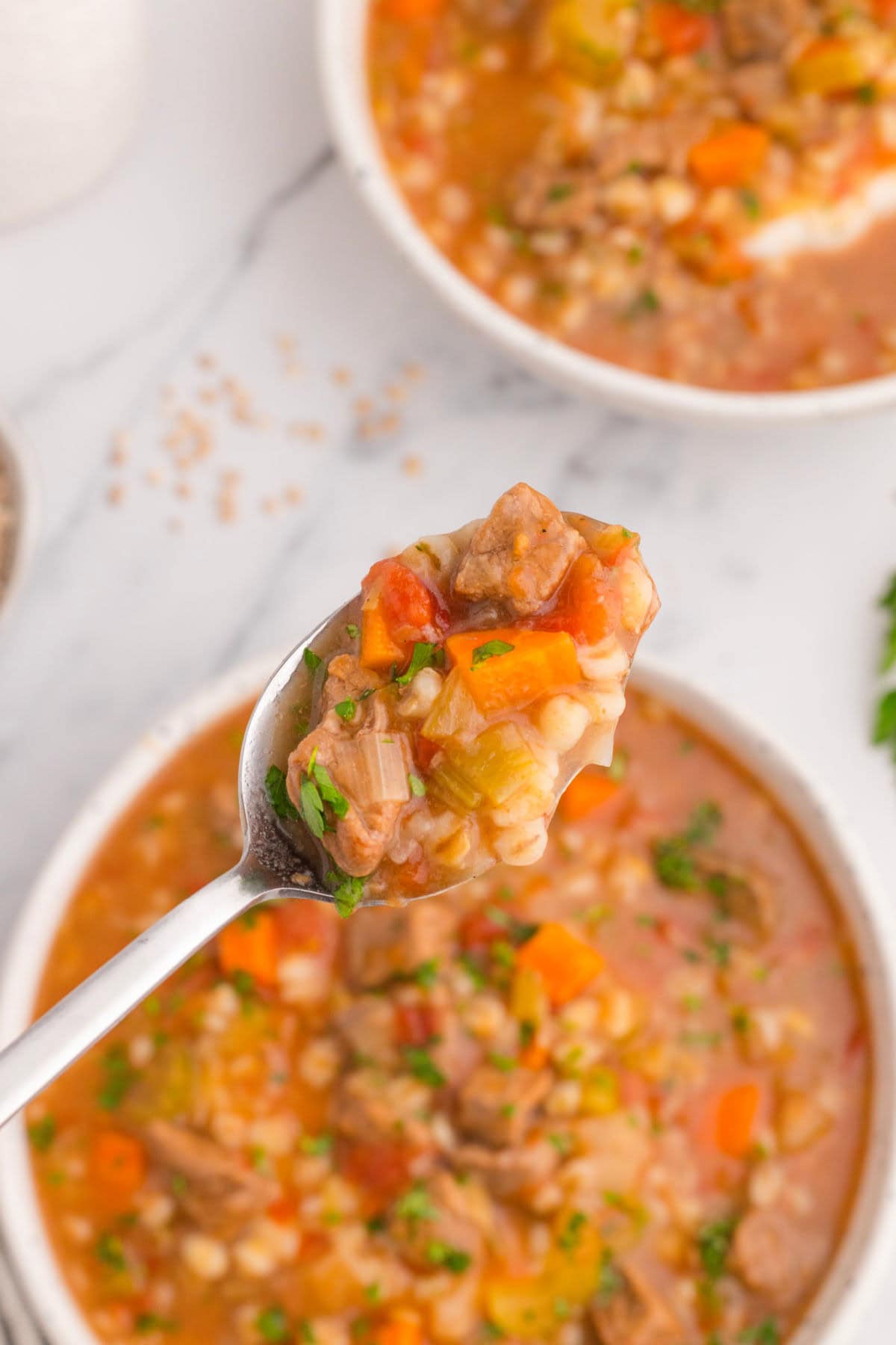 A spoonful of soup being removed from the bowl.