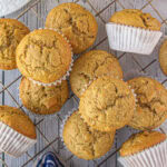 A batch of brown butter banana pecan muffins cooling on a rack.