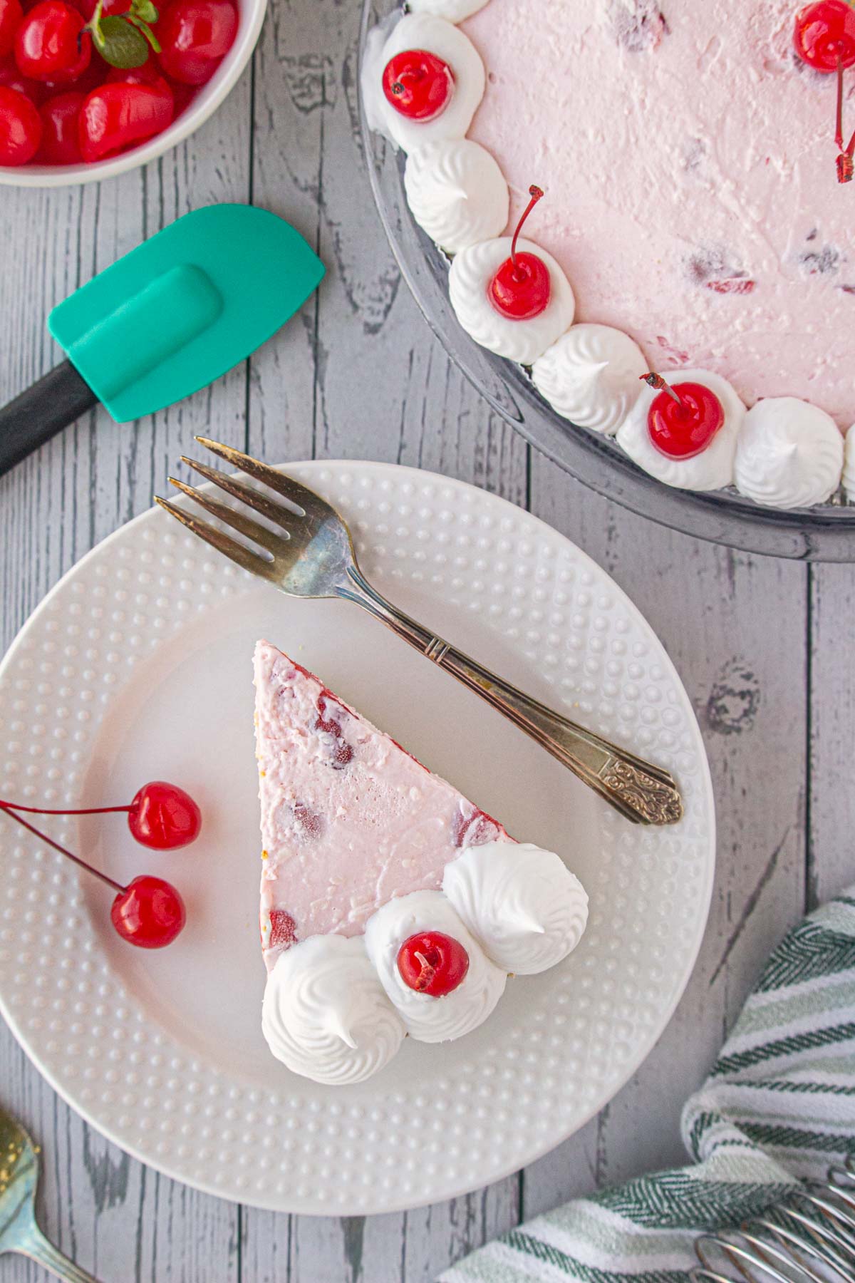 An overhead view of a slice of cherry icebox pie on a dessert plate.