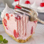 Slice of cherry icebox pie being cut with a fork.