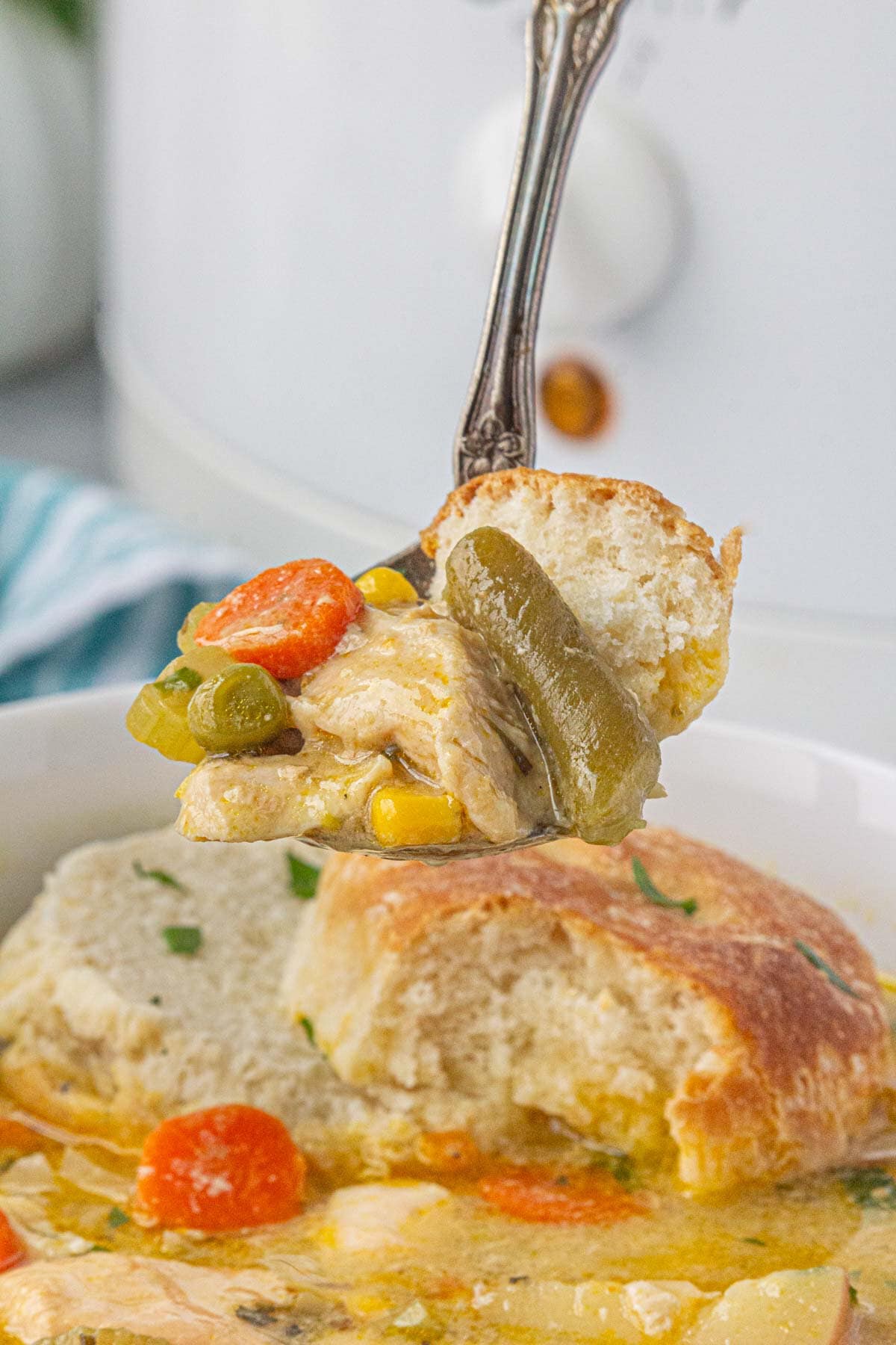 A close-up view of a spoonful of chicken pot pie soup.