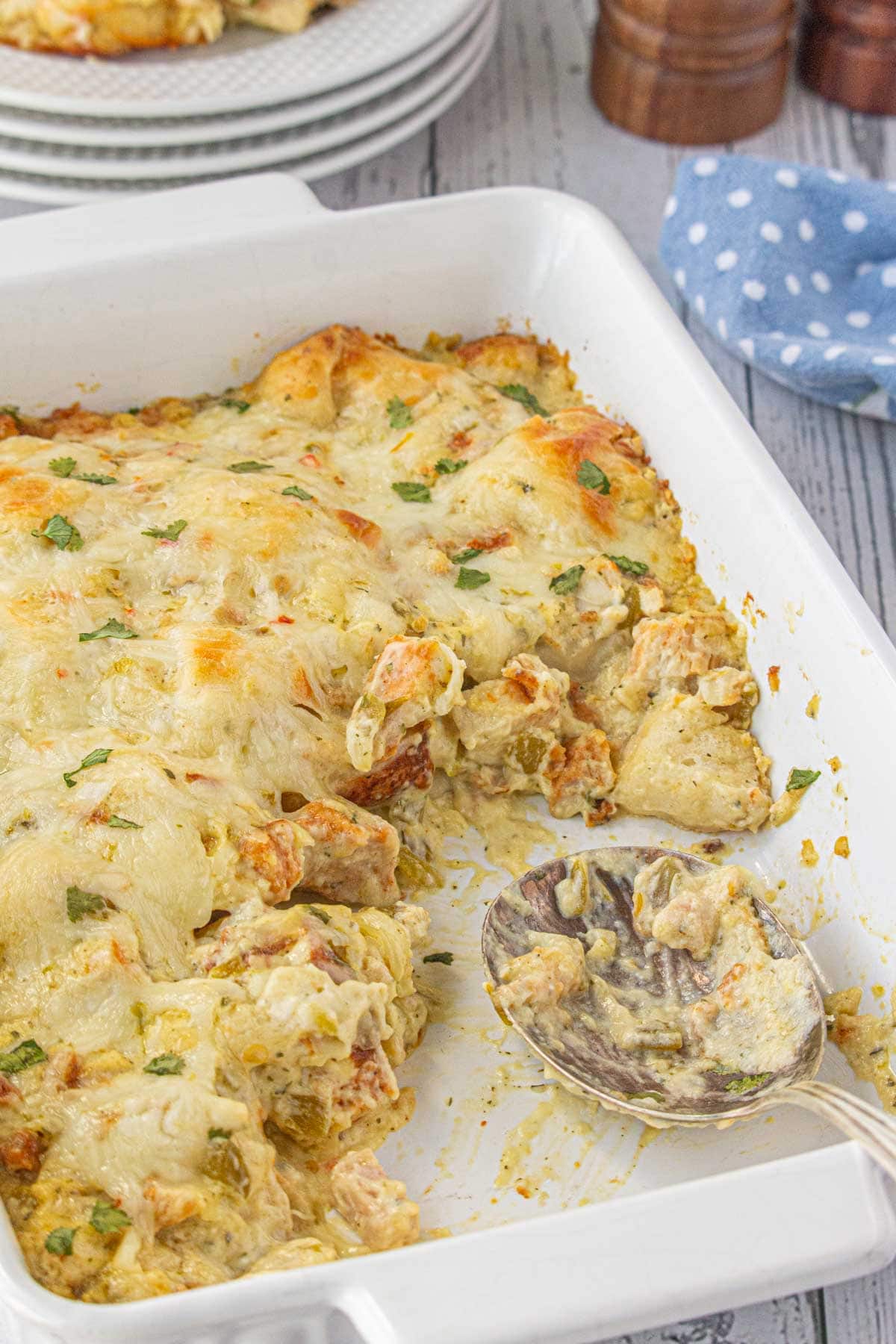 An angled view of chile chicken bubble up bake with a serving spoon.