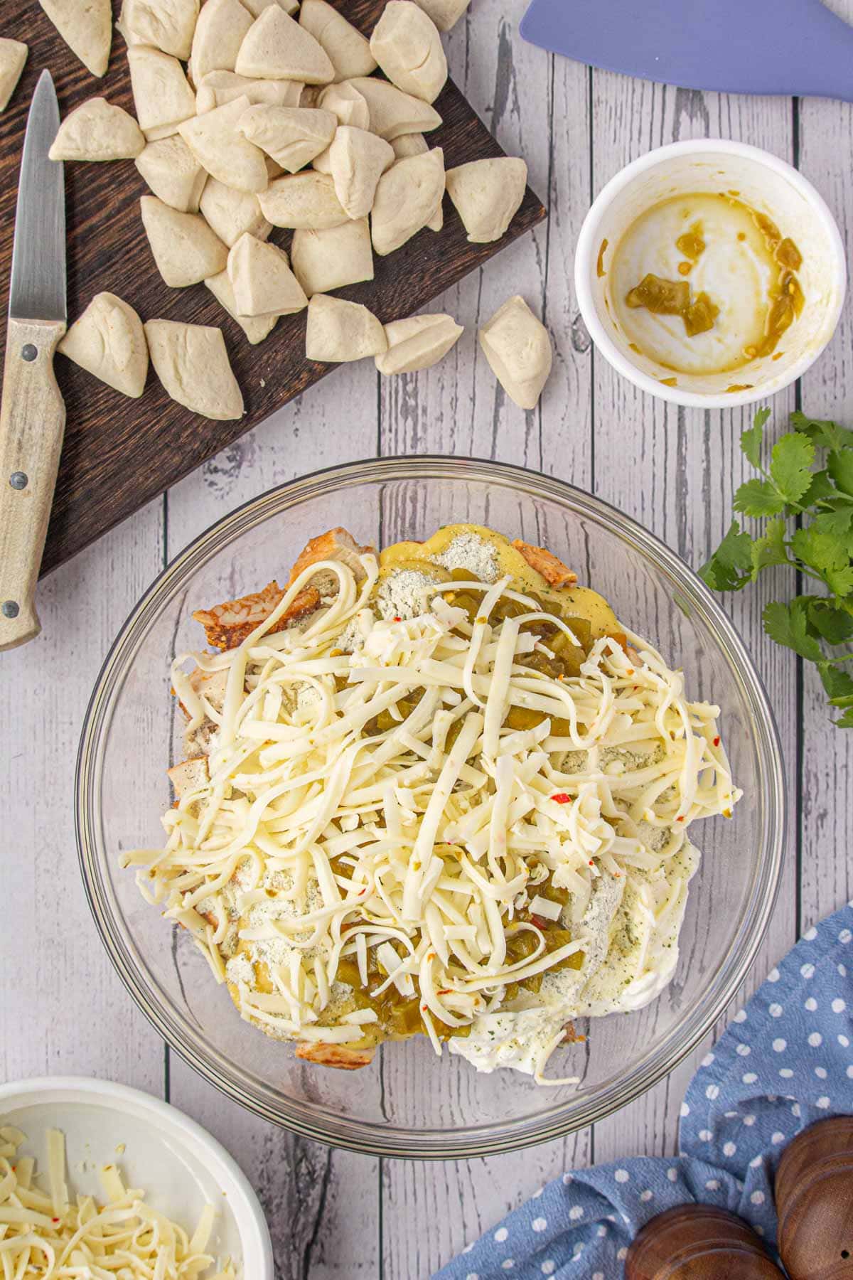 The chiles and cheese added to the ingredients bowl.