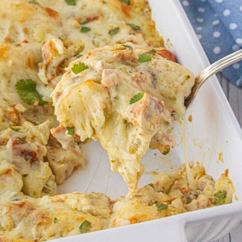 Chile chicken bubble up being removed from a casserole dish.