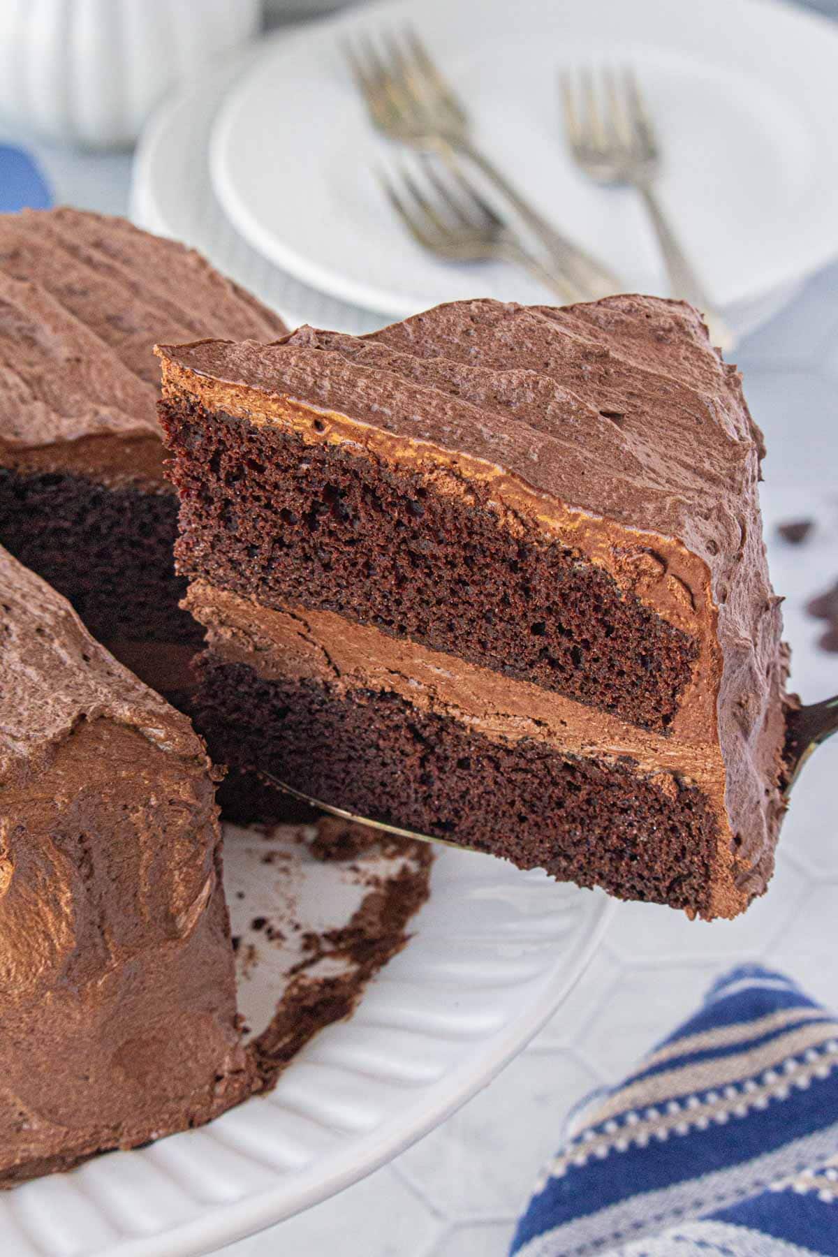 An angled view of removing a slice of Hershey's perfect chocolate cake on a cake server.