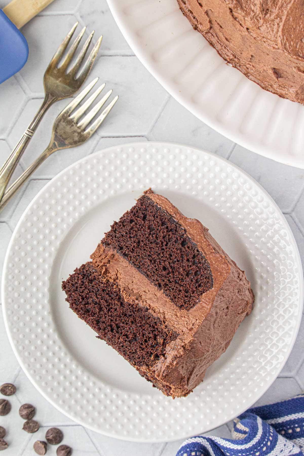 An overhead view of a slice of Hershey's perfect chocolate cake on a dessert plate.