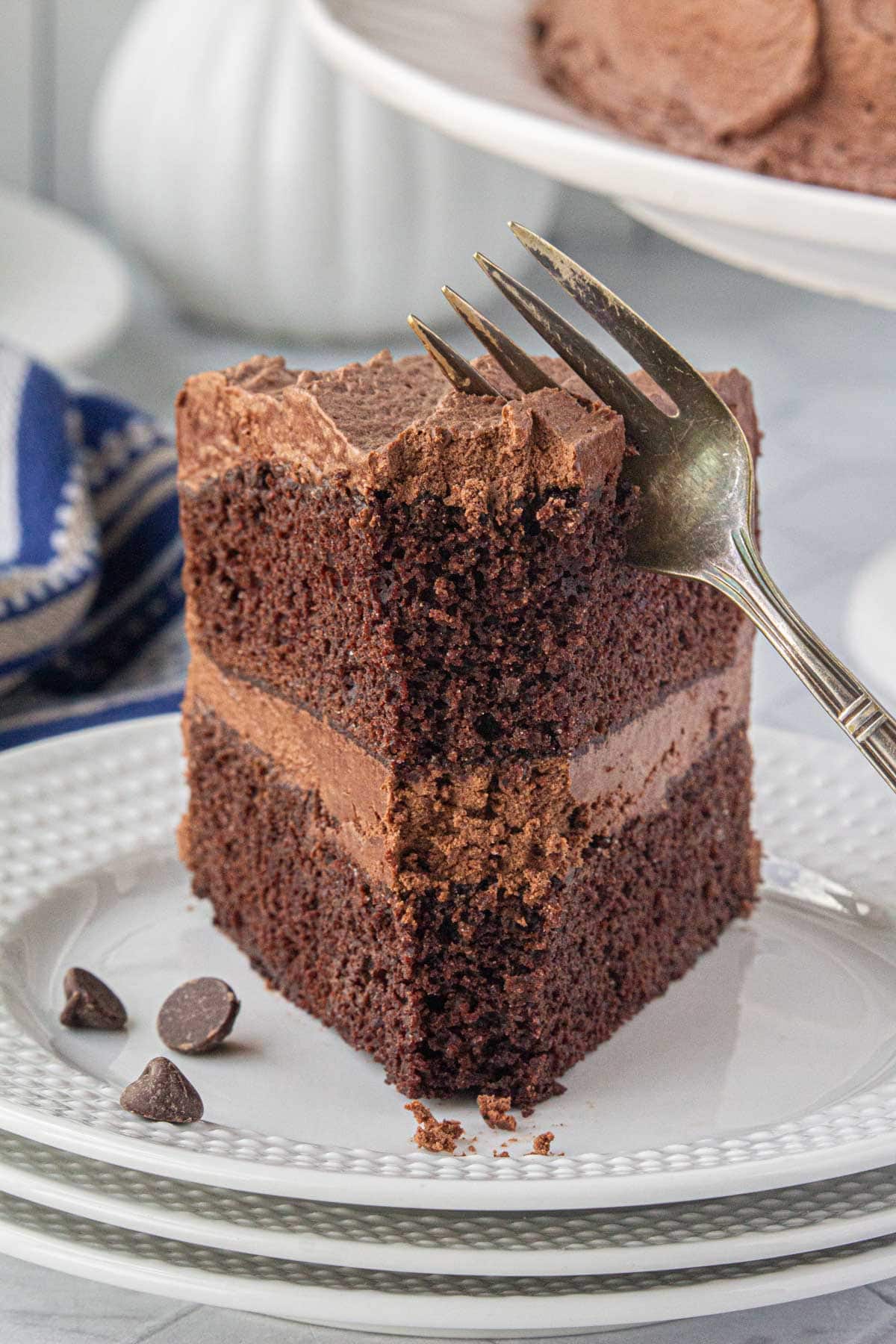 A side view of a fork cutting into a slice of Hershey's perfect chocolate cake.