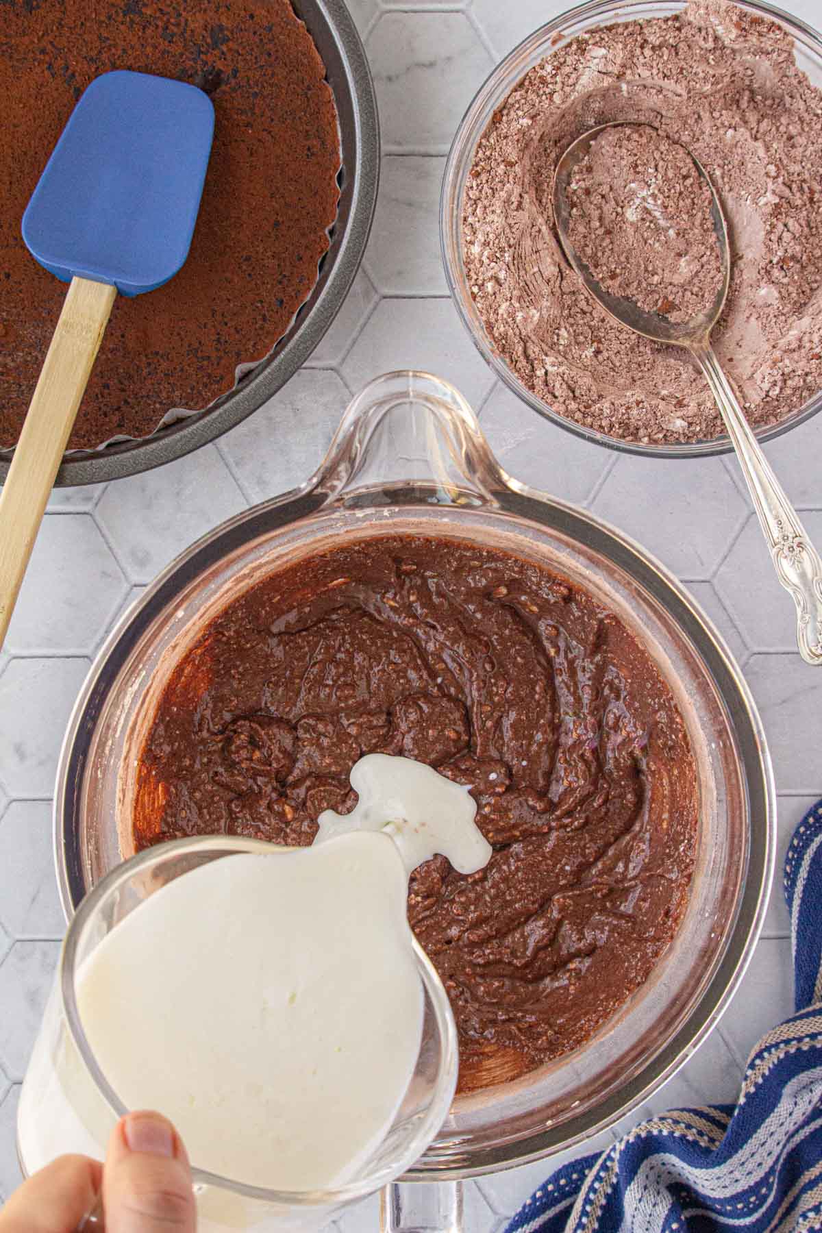 Adding the buttermilk to the cake batter.