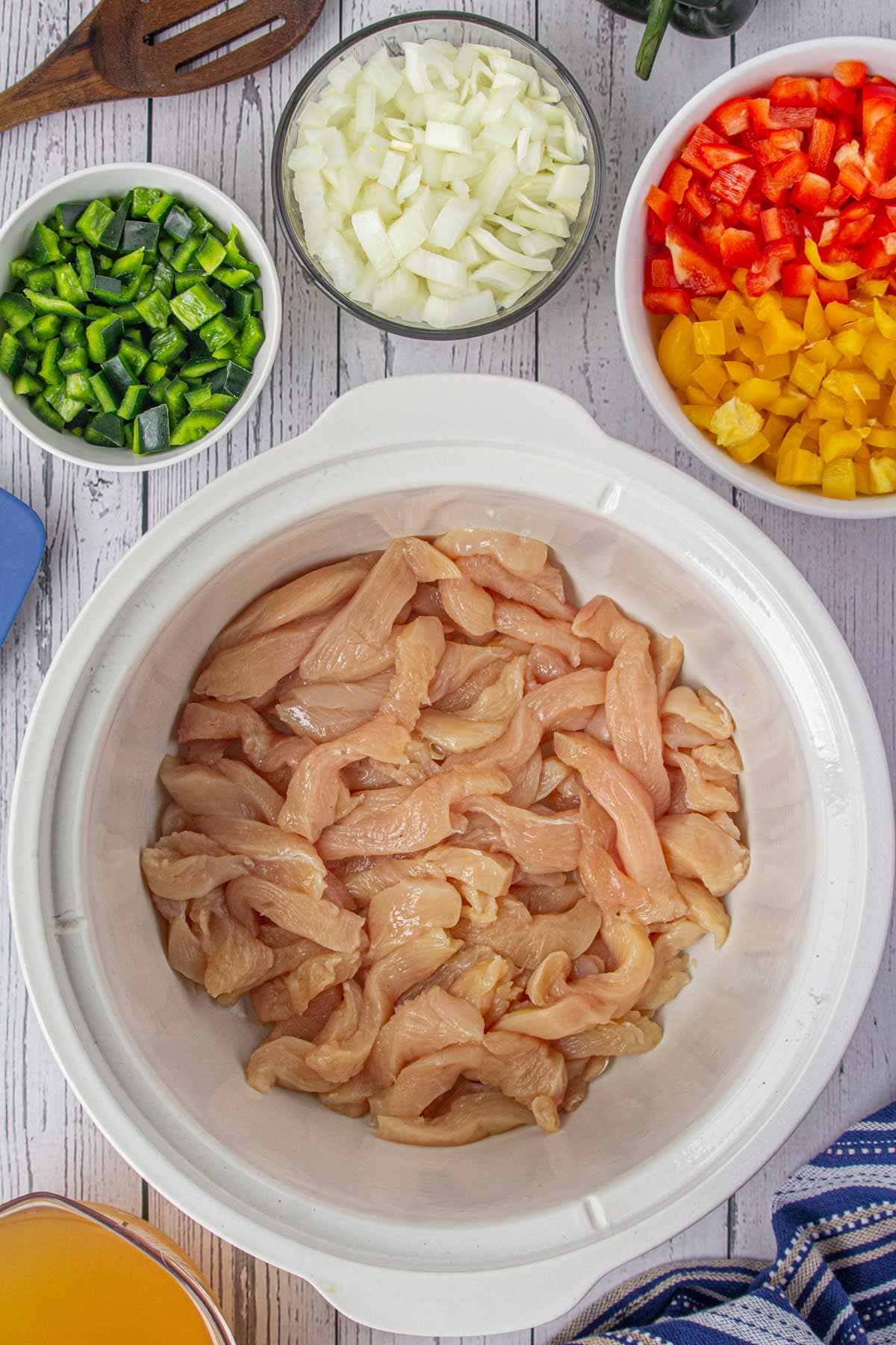 Chicken in the bottom of the slow cooker.