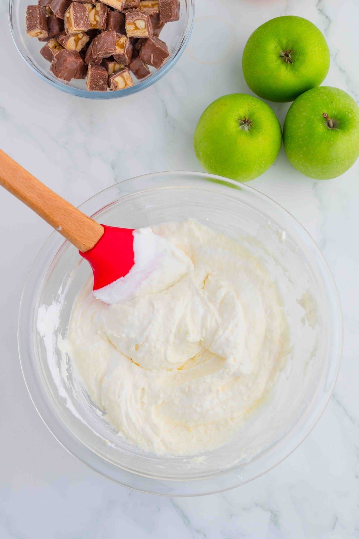 Gently folding the Cool Whip into the pudding.