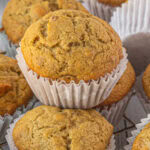 Close up of a stack of banana pecan muffins with a title text overlay for Pinterest.