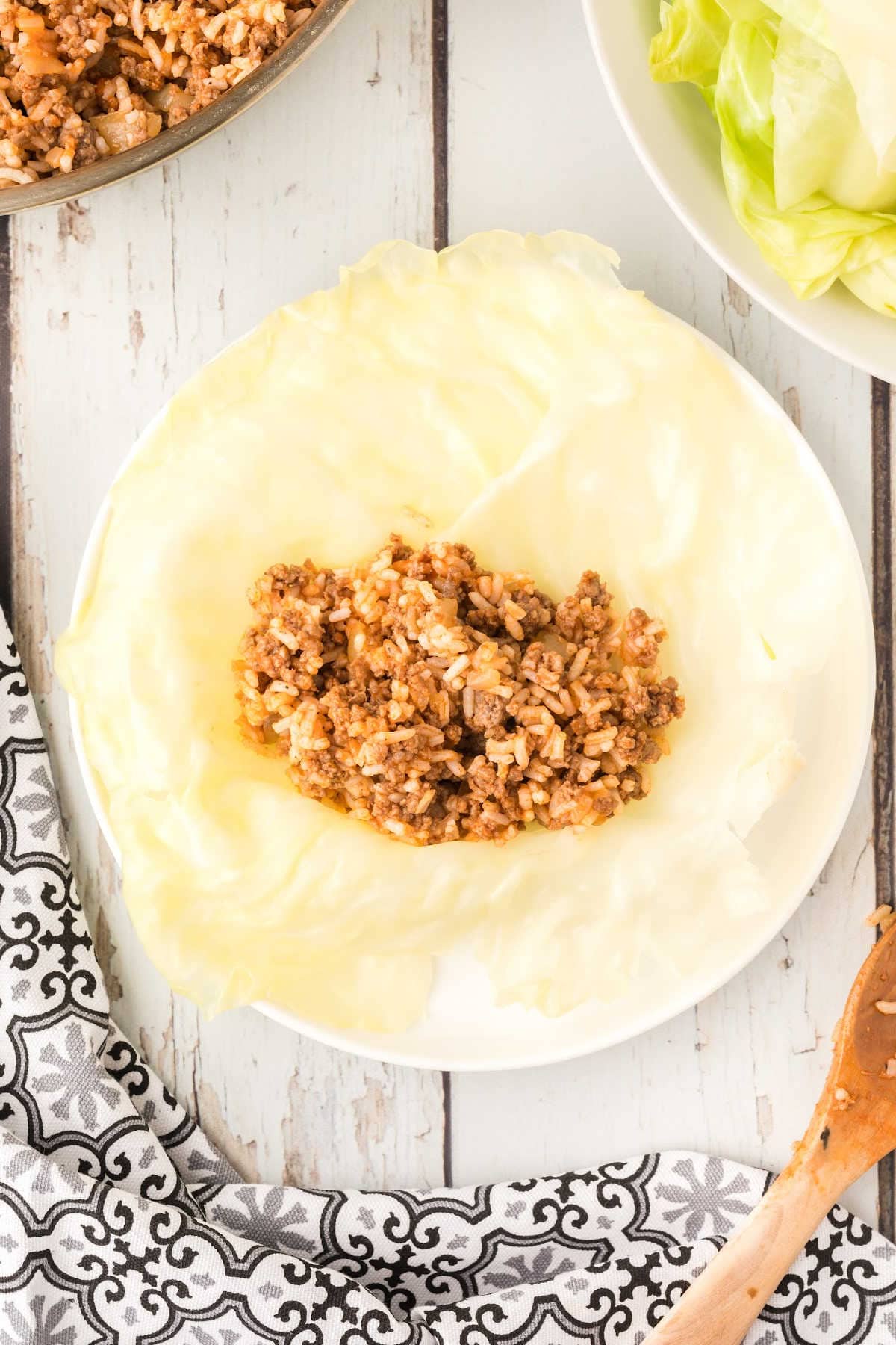 Cooked ground beef and rice mixture on steamed cabbage leaf.