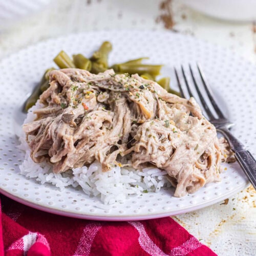 Creamy slow cooked pork tenderloin shredded and served over rice.