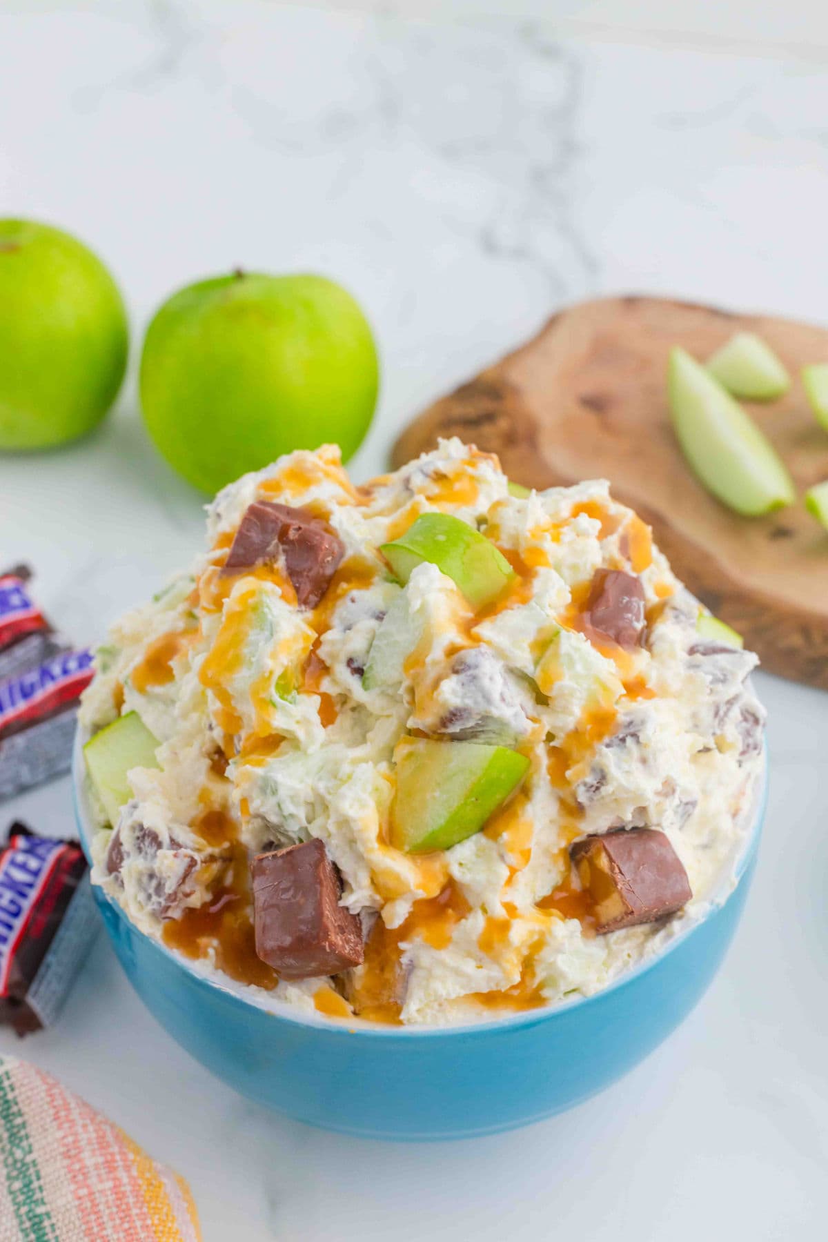 An angled view of Apple Snickers Salad in a dessert bowl.