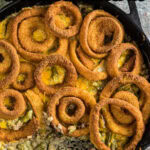 Overhead view of beef and green bean casserole with a title text overlay for Pinterest.