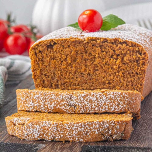 Sliced tomato cake with powdered sugar on top.