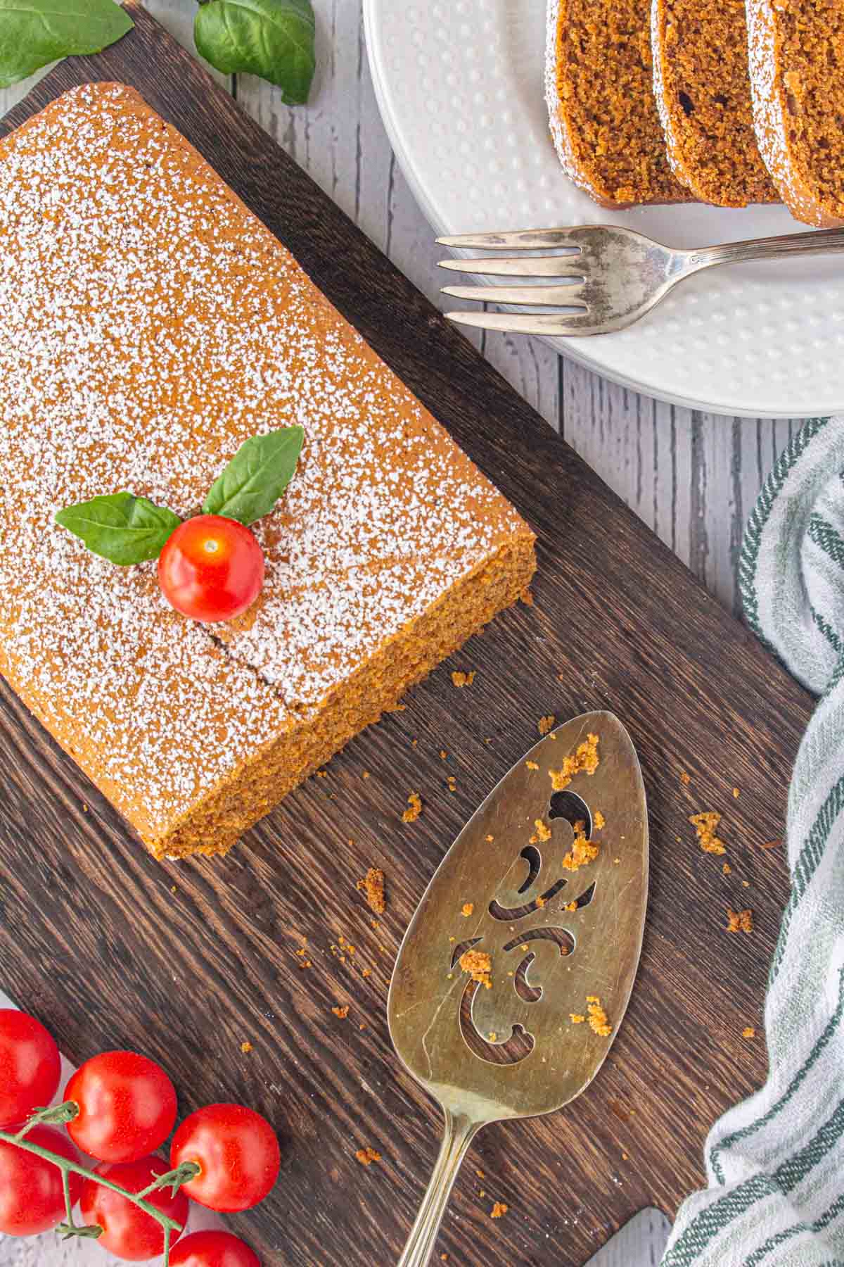 An overhead view of Aunt Lenore's tomato cake partially sliced. 