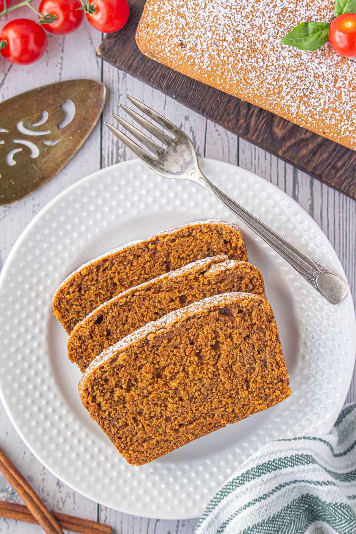 An overhead view of three slices of tomato cake on a dessert plate.