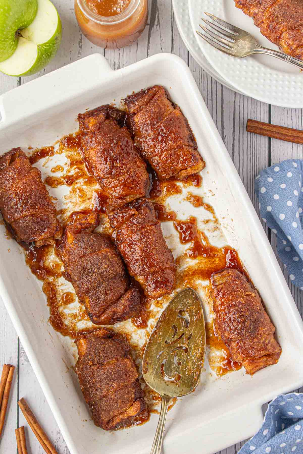 On overhead view of crescent roll apple dumplings in a casserole dish.