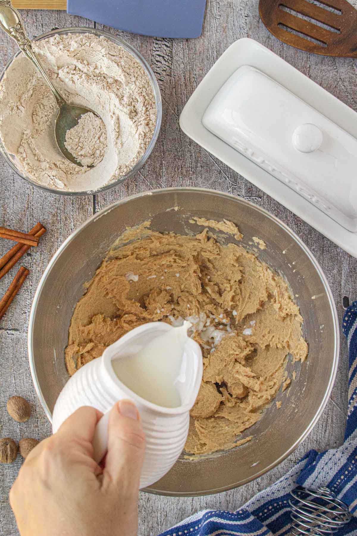 Adding the milk and dry ingredients to the beaten mixture.