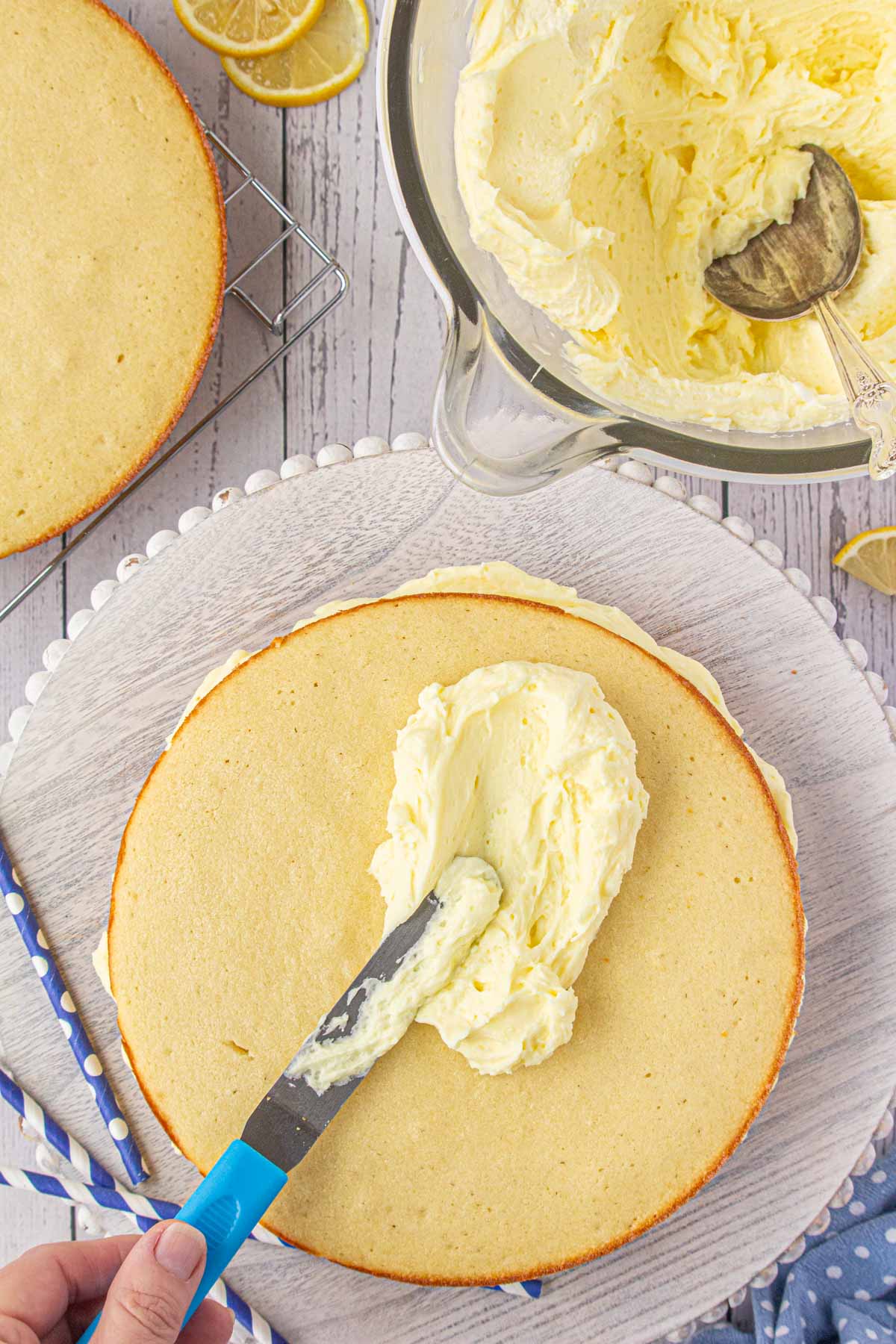 Frosting the moist lemon cake.