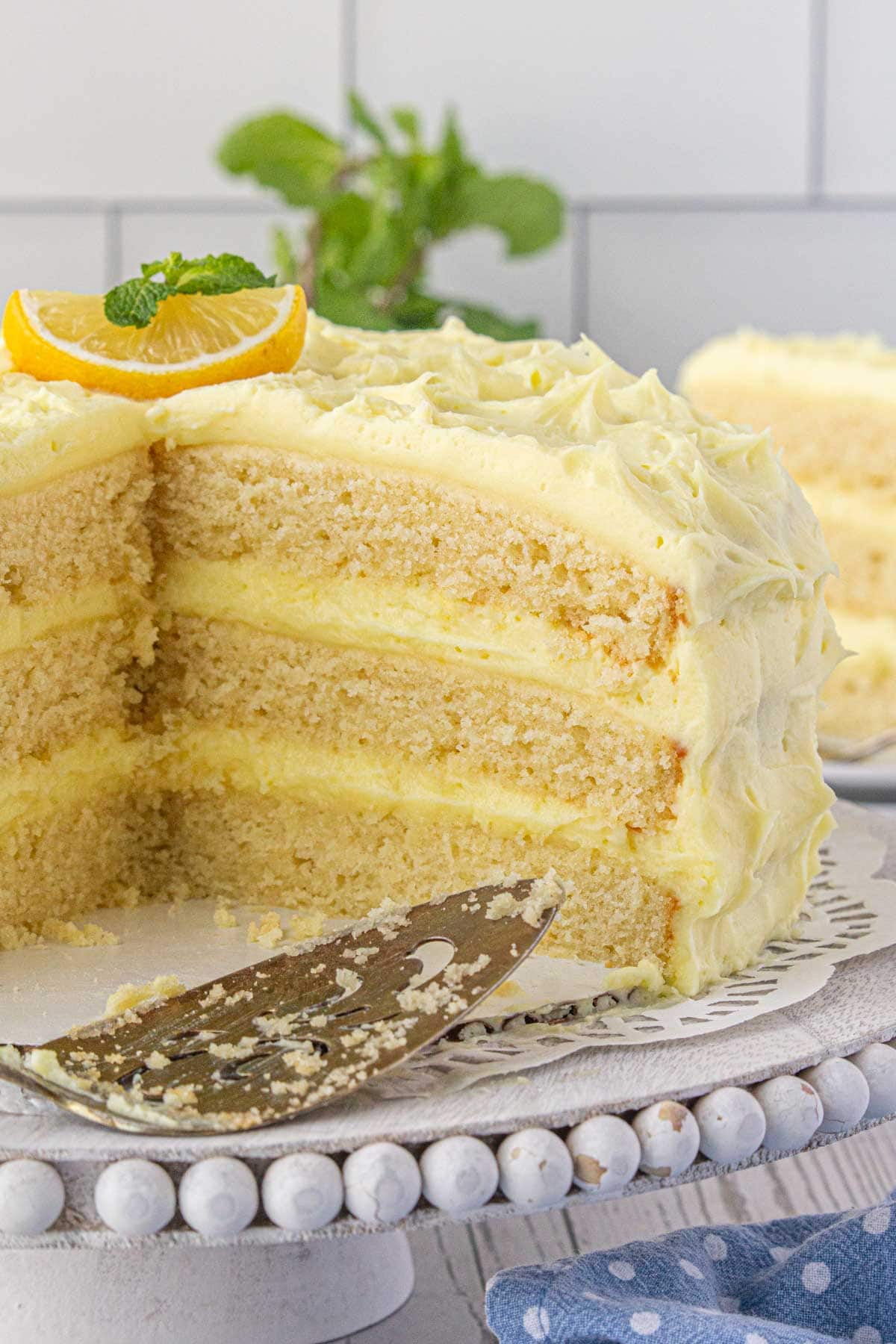 An interior view of the moist lemon cake with a big slice removed.