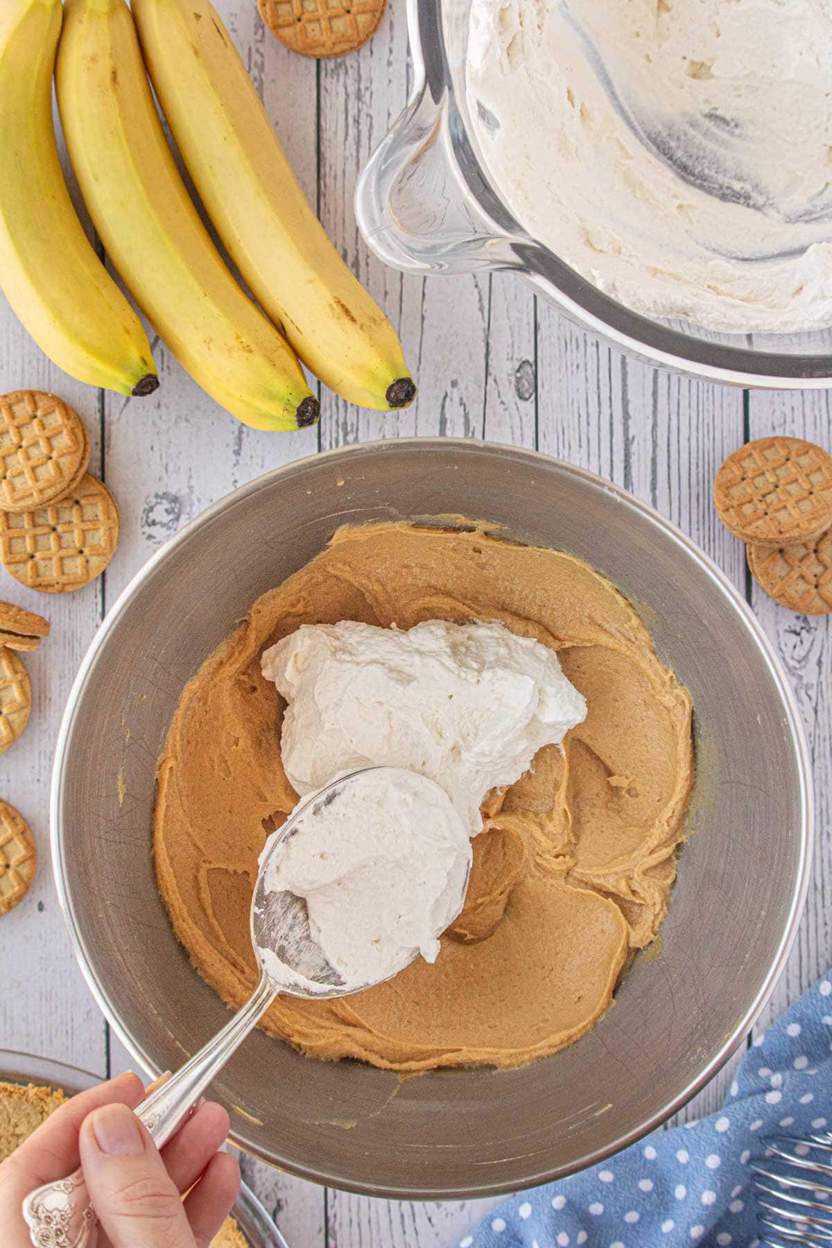 Folding the whipped cream into the peanut butter mixture.