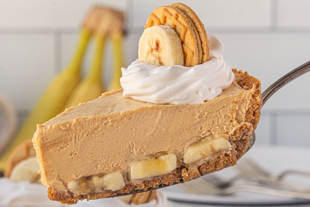 A slice of peanut butter banana icebox pie showing the layers of bananas and peanut butter.