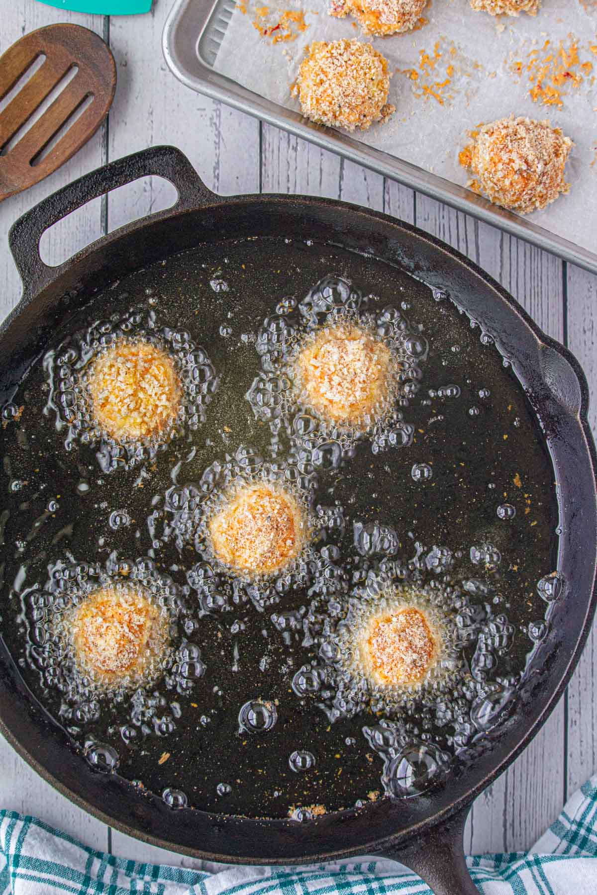 Frying the pimento cheese balls.