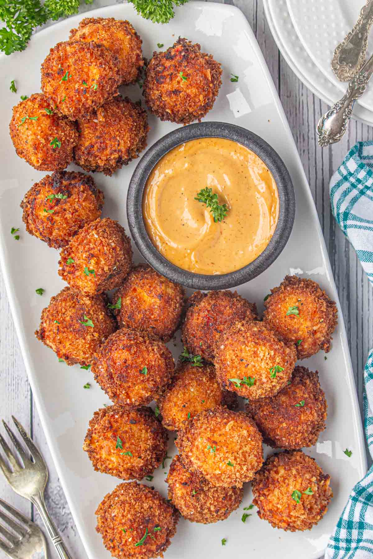 An overhead view of crispy fried pimento cheese balls on a serving dish.